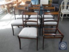 A set of eight mahogany brass inlaid dining chairs (one seat pad missing)
