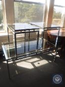 A contemporary metal glass topped coffee table together with a pair of matching side tables