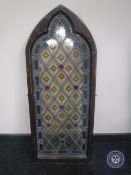 A stained glass church window in an arched frame CONDITION REPORT: 41.