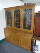 A continental blond oak triple door dresser
