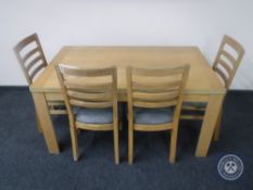 A contemporary oak effect dining table together with a set of four ladder back chairs