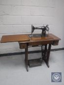 A Singer treadle sewing machine in oak table