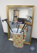 A gilt framed mirror together with a stick pot with rose decoration and four folding walking sticks