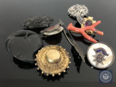 A Victorian pinchbeck memorial brooch, coral brooch, amethyst pendant, silver and jet brooches,