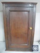An antique pine hanging corner cupboard