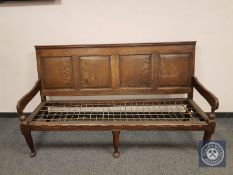 A George III panelled oak settle,