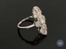 An 18ct white gold diamond ring featuring five bezel set round brilliant cut diamonds 1.