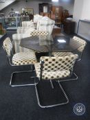 A mid 20th century smoked glass top dining table on metal base together with a set of four kitchen