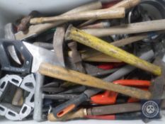 A crate of hand tools and hammers