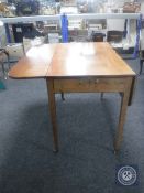 A Victorian mahogany flap sided table fitted a drawer