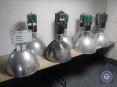 Seven fawn industrial halogen lights and one other