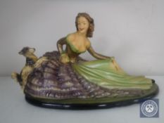 An Art Deco chalk figure of a lady seated with a dog