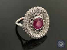 An 18ct white gold ruby and diamond ring, featuring one round cut natural ruby 1.