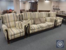 A three piece wingback lounge suite upholstered in a striped print