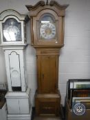 A continental oak longcase clock with later brass moon phase dial,