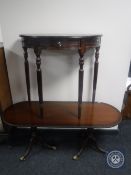 A mahogany D-shaped hall table and a mahogany oval coffee table