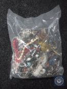A bag containing a large quantity of costume jewellery