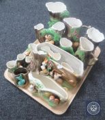 A tray containing fourteen assorted fauna ware vases