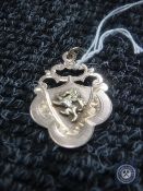 A 9ct gold sporting medallion, 2.9g, dated 1921 for Loughbrough Rugby Football club.