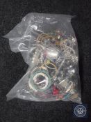 A bag containing a large quantity of costume jewellery