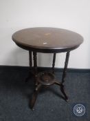 A circular inlaid mahogany lamp table