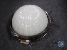 An Art Deco style light fitting with opaque glass shade