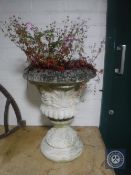 A concrete garden urn on stand