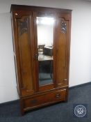 An Edwardian mahogany mirror door wardrobe