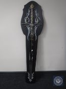 A fantasy sword mounted on a wooden board