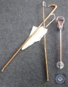 Two shepherds crooks together with a parasol and shooting stick