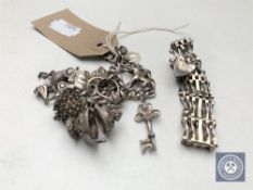 A silver gate bracelet together with a silver charm bracelet with charms