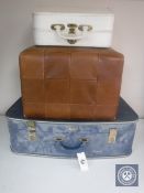 A mid 20th century luggage case together with two vanity cases and brown leather footstool