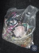 A bag containing a large quantity of costume jewellery