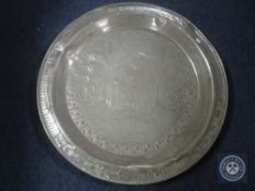 An Eastern brass wall plaque