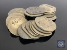 Twenty vintage brass railway pay check tokens.