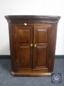 A Georgian mahogany double door corner cabinet