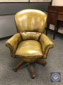 An olive green leather swivel office chair,