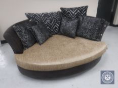 A love seat upholstered in two tone fabric with scatter cushions