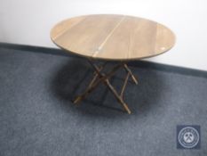 An early 20th century circular folding campaign style table