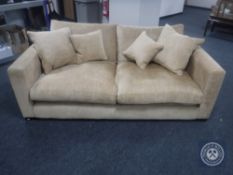 A pair of settees with scatter cushions in a sand coloured fabric