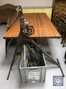 A pipe bender and a crate of hand saws, spirit levels, oil gun,