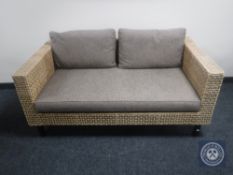 A John Lewis rattan framed two seater settee