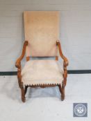A carved beech framed continental scroll armchair