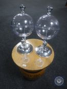 A barrel stool together with two globe drinks dispensers