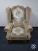 A wingback armchair upholstered in floral print