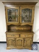 A glazed oak kitchen dresser