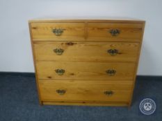 A pine five drawer chest with brass drop handles