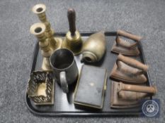 Three vintage flat irons, brass candlesticks,