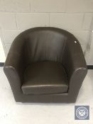 A brown leather tub chair