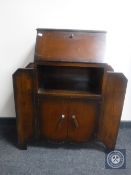 A 1930's oak bureau with shelves either side